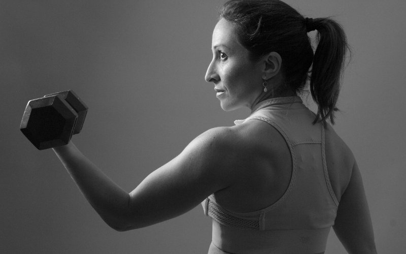 Woman performing strength training at Oshawa wellness centre for menopause